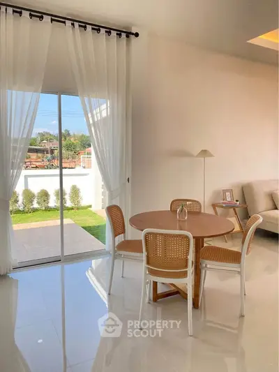 Bright modern living room with elegant dining set and garden view