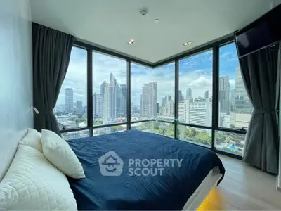 Luxurious bedroom with panoramic city skyline view and floor-to-ceiling windows.