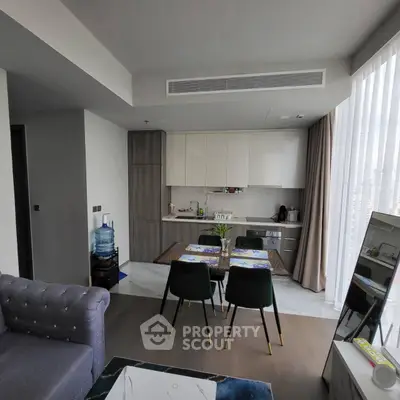 Modern open-layout kitchen and dining area with sleek design and natural light.