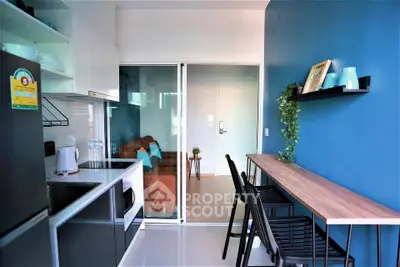 Modern kitchen with open layout and stylish dining area in a compact apartment