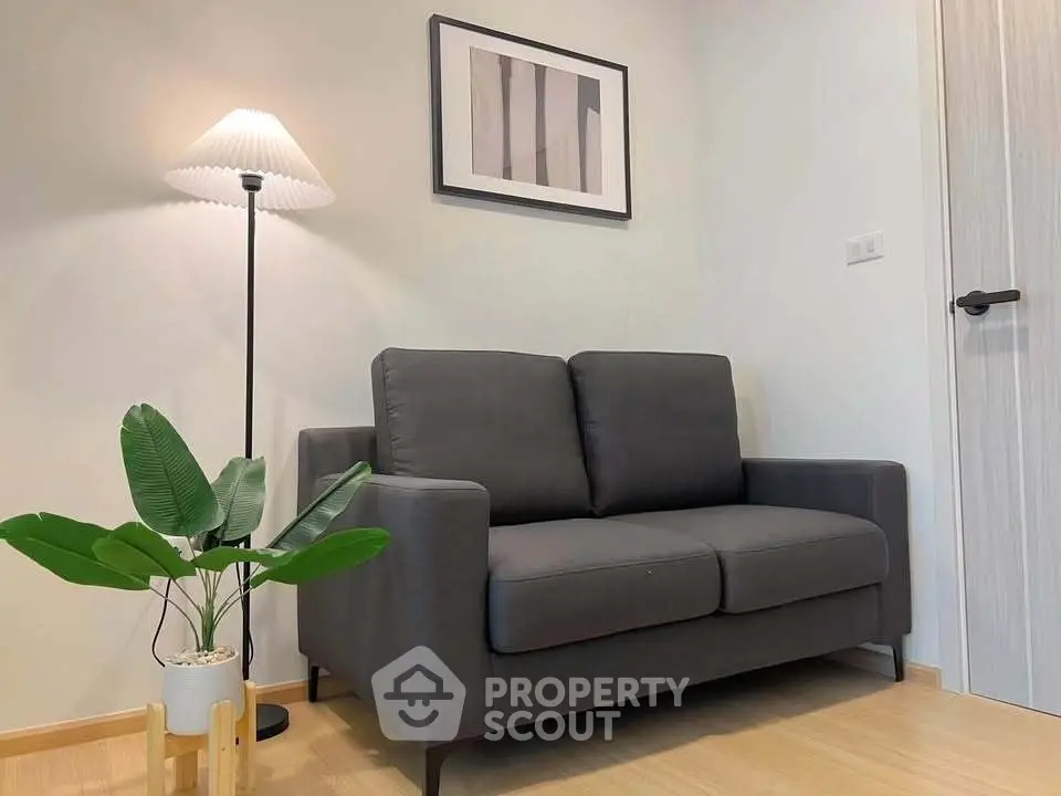 Cozy living room with modern gray sofa and stylish floor lamp, perfect for relaxation.