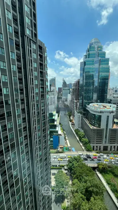 Stunning cityscape view from high-rise building with modern architecture and lush greenery.