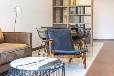 Modern living room with stylish furniture and marble flooring in a contemporary apartment.