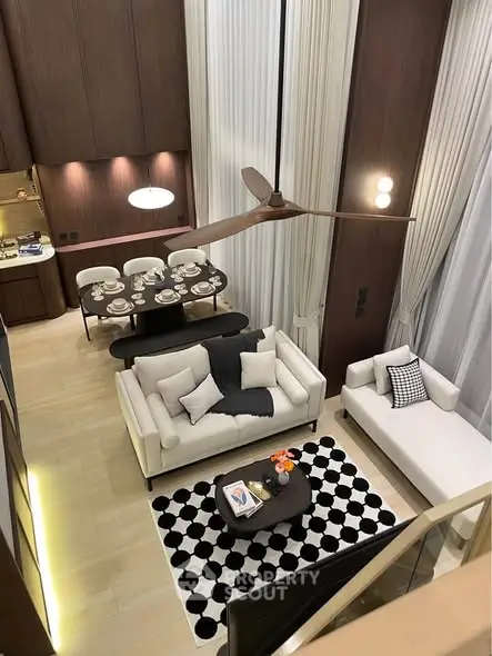 Luxurious modern living room with high ceilings and elegant dining area