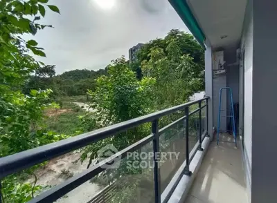 Spacious balcony with lush green view, perfect for relaxation and enjoying nature.