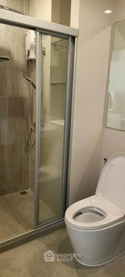 Modern bathroom with glass shower and sleek toilet design