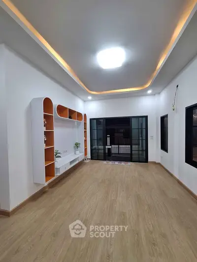 Spacious modern living room with built-in shelves and stylish lighting
