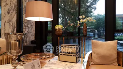 Luxurious living room with marble decor and elegant furnishings overlooking a serene garden view.