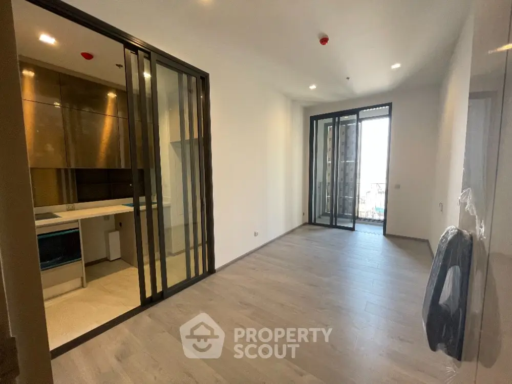 Modern apartment interior with open layout and balcony access