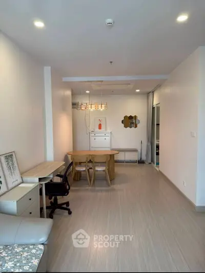 Spacious modern living room with stylish furniture and elegant lighting, perfect for comfortable living.