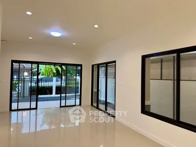 Spacious modern living room with large windows and garden view