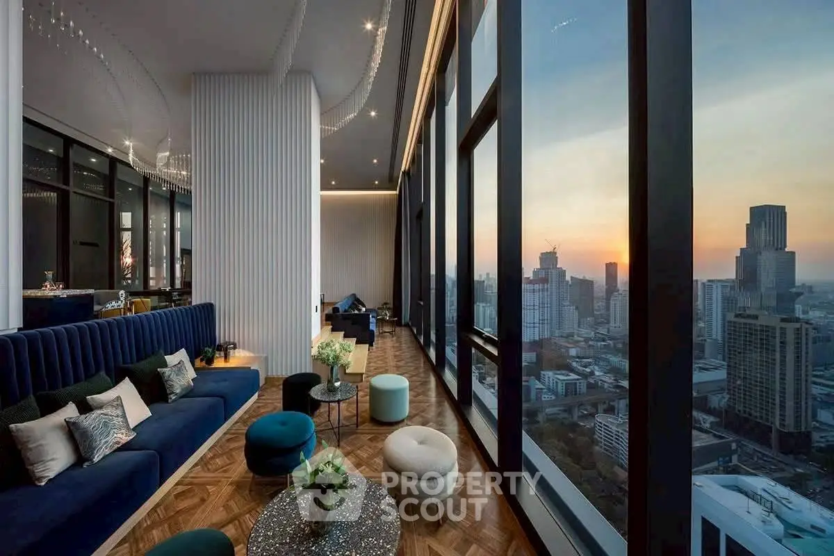 Luxurious high-rise living room with panoramic city views at sunset.