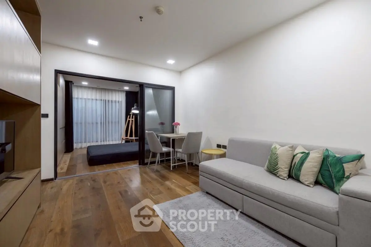 Modern living room with cozy sofa and stylish decor in open layout apartment.