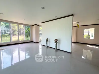 Spacious modern living room with large windows and elegant decor