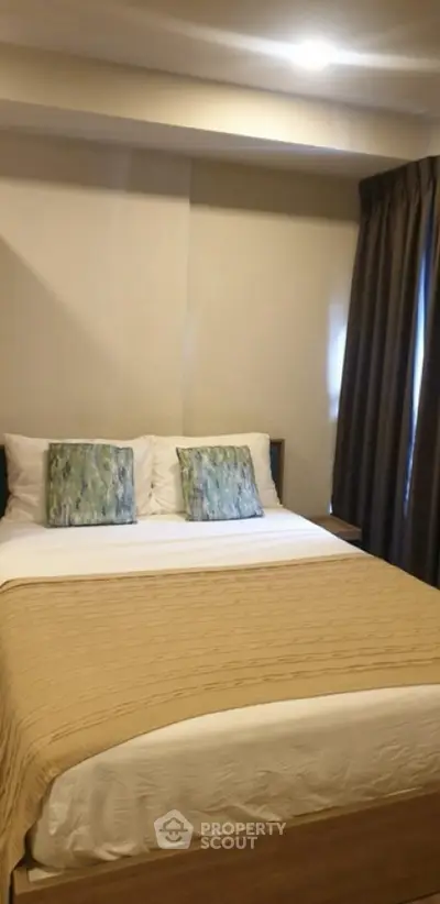 Cozy bedroom with modern decor and soft lighting, perfect for relaxation.