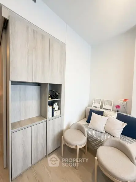 Modern living room with stylish furniture and built-in storage cabinets