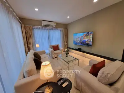 Spacious living room with modern decor and large windows for natural light.