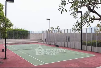 Spacious outdoor tennis court in modern residential complex