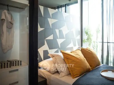 Modern bedroom with geometric accent wall and large windows