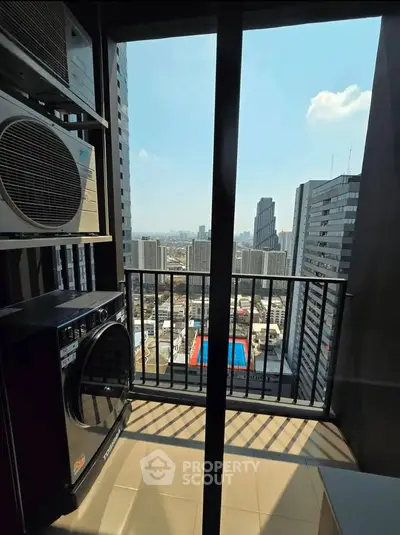 High-rise balcony with cityscape view and modern appliances, perfect for urban living.