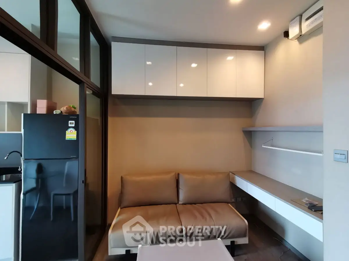 Modern living room with sleek furniture and integrated kitchen area