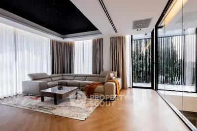 Luxurious modern living room with large windows and elegant decor