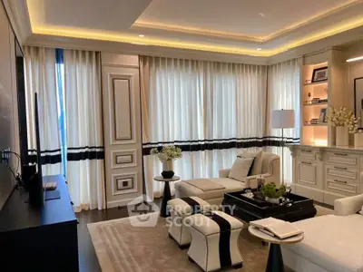 Luxurious living room with elegant decor and natural light, featuring plush seating and stylish shelving.