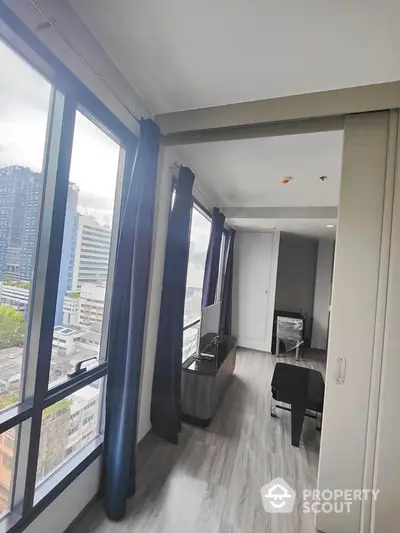 Modern condo interior with large windows and city view