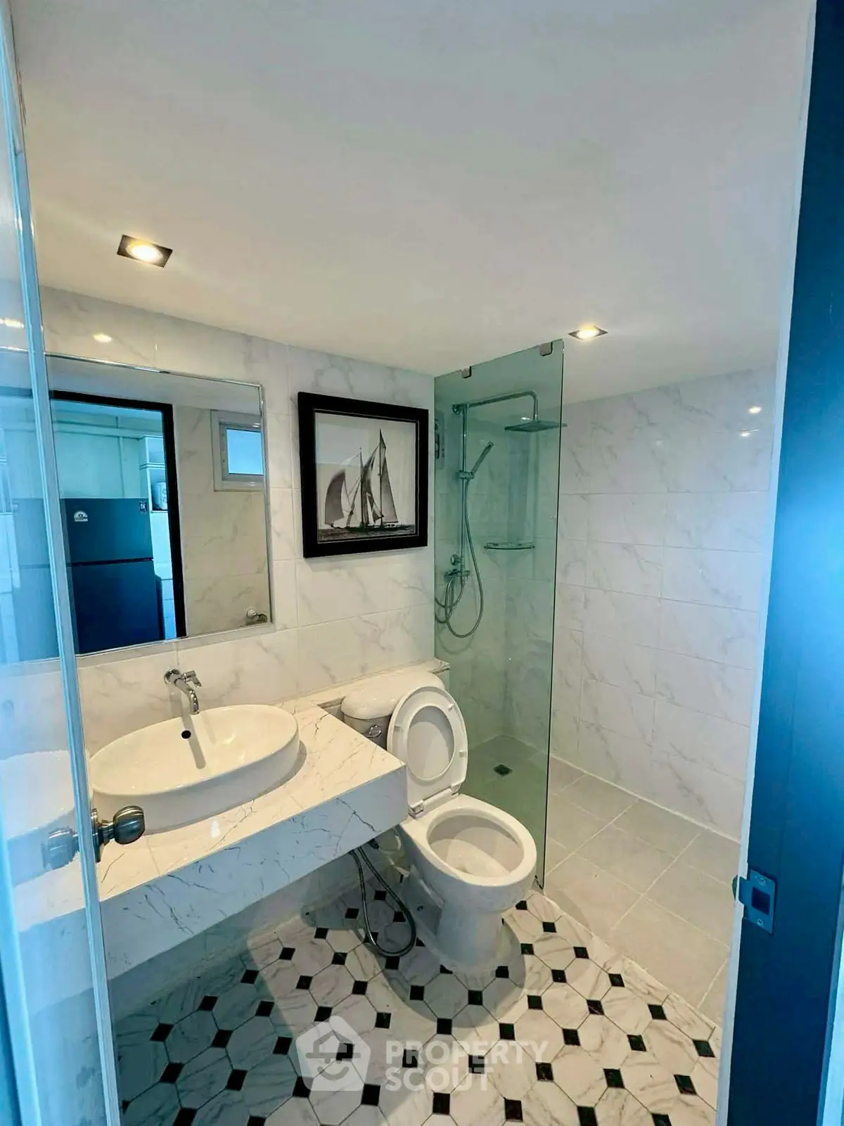 Modern bathroom with glass shower and marble sink in stylish real estate property.