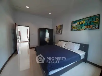 Spacious bedroom with modern decor and comfortable bedding