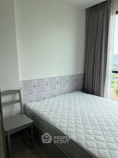 Cozy bedroom with modern decor and large window view