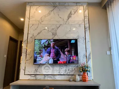 Luxurious living room with marble TV wall and elegant decor