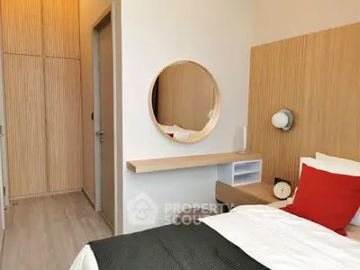 Modern bedroom with stylish decor and cozy ambiance, featuring a round mirror and wooden accents.