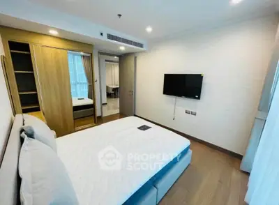 Modern bedroom with stylish decor and built-in wardrobe in a contemporary apartment.