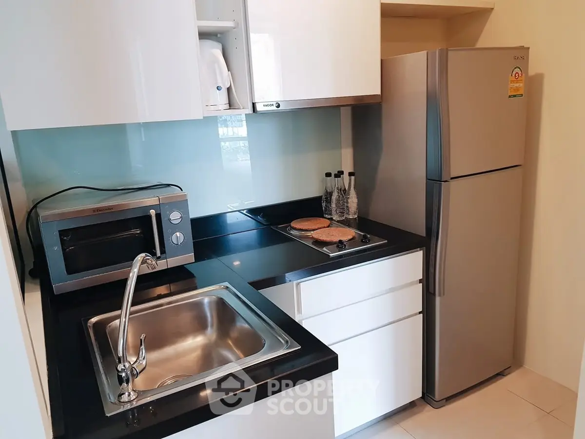 Modern compact kitchen with sleek appliances and stylish design