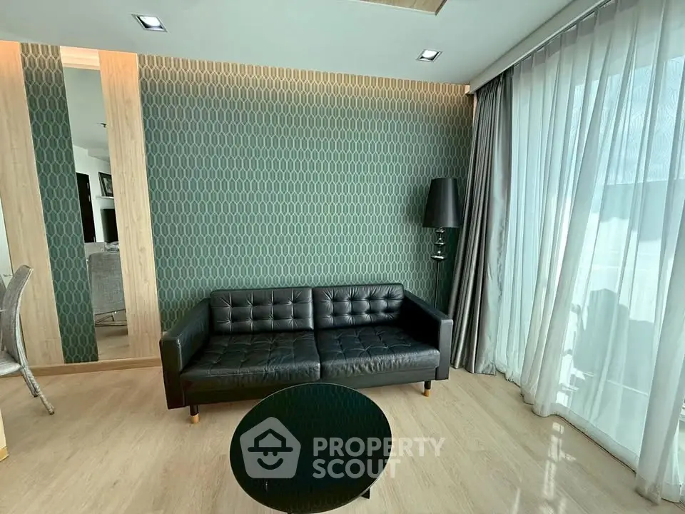 Stylish modern living room with black leather sofa and elegant decor