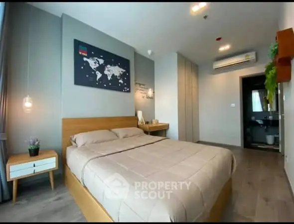 Modern bedroom with stylish decor and ensuite bathroom in a contemporary apartment.