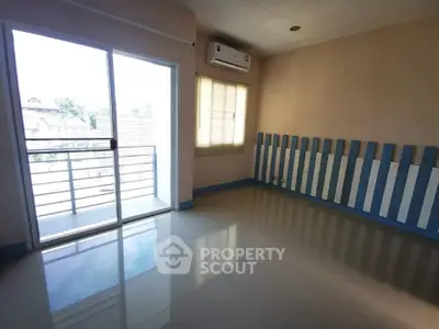 Spacious empty room with balcony access and air conditioning, perfect for customization.