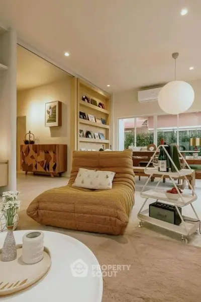 Stylish living room with modern decor and cozy seating, perfect for relaxation and entertaining.