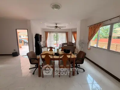 Spacious dining area with natural light and garden view, perfect for family gatherings.