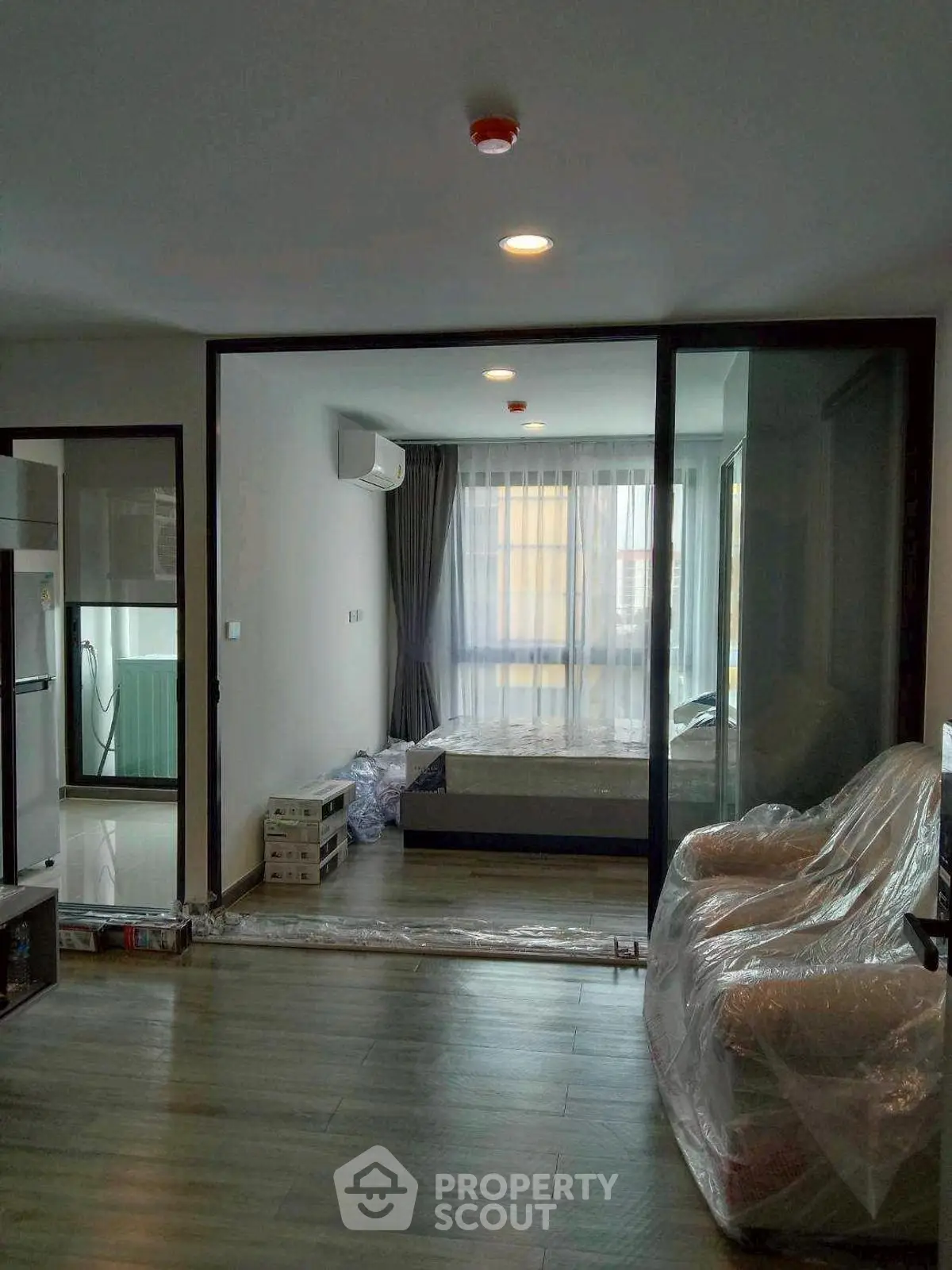 Modern apartment interior with open layout and large windows for natural light.