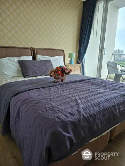 Luxurious bedroom with elegant decor and city view balcony access.