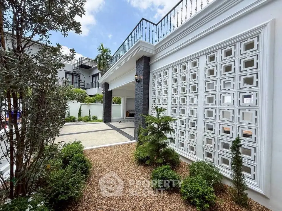 Elegant modern building exterior with stylish facade and lush landscaping, perfect for luxury living.