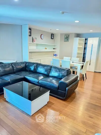 Spacious living room with modern leather sofa and elegant dining area