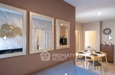 Stylish living room with modern decor and dining area in open layout apartment.