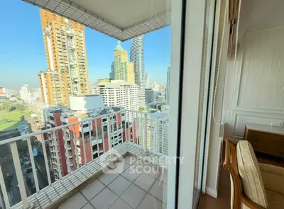 Stunning city view from a high-rise balcony with modern urban skyline.