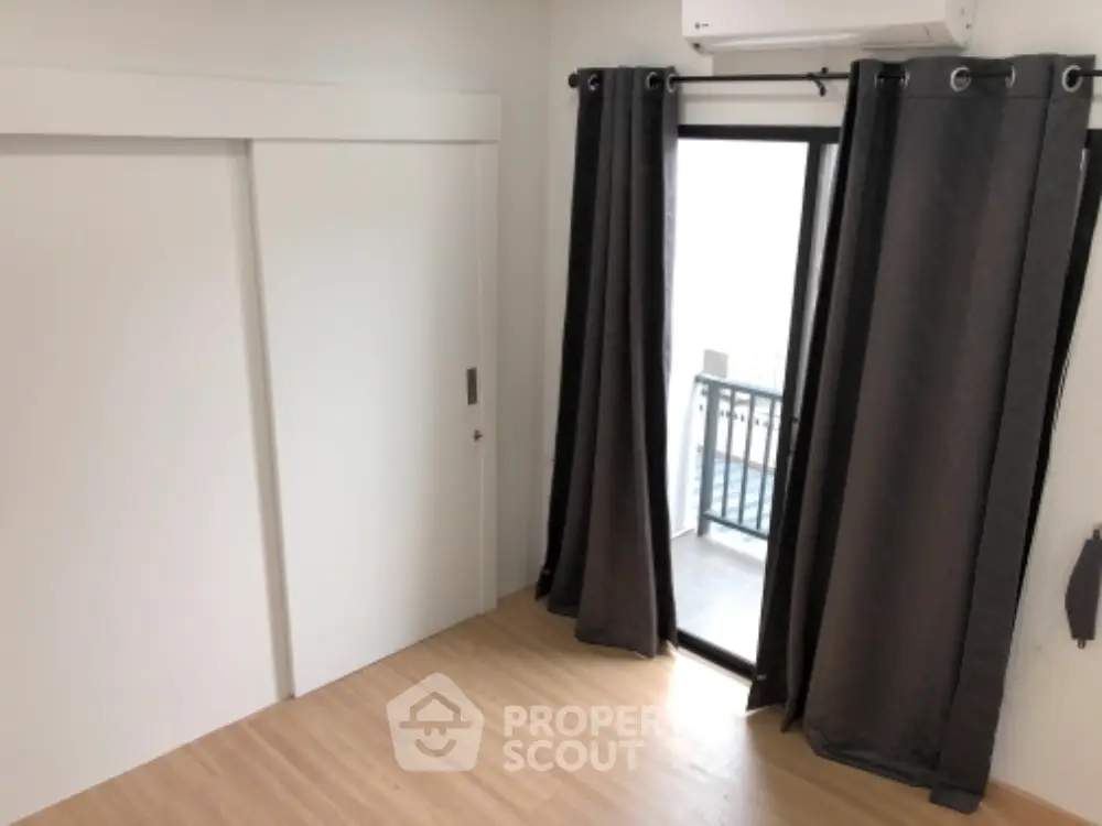 Modern bedroom with sliding closet doors and balcony access.