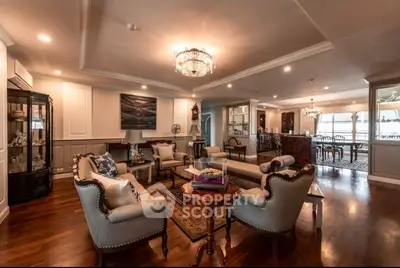 Luxurious living room with elegant furniture and chandelier lighting in a spacious open layout.