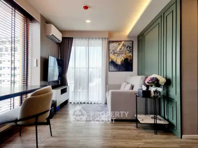 Modern living room with stylish decor, large window, and comfortable seating in a contemporary apartment.
