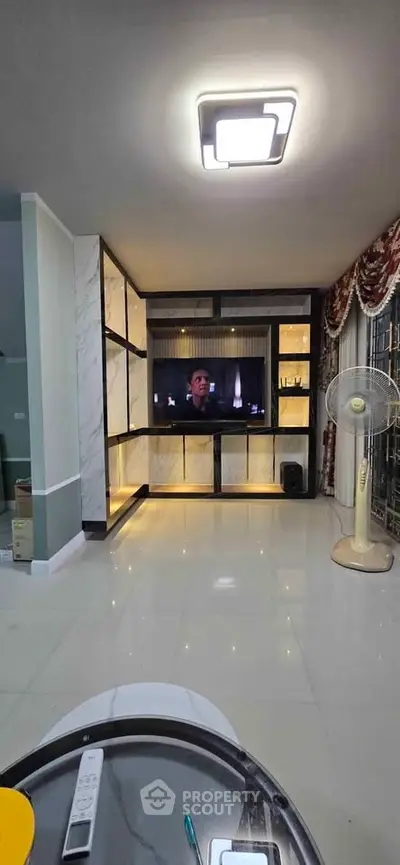Spacious living room with modern TV setup and elegant decor